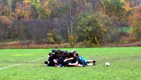 Students pray on soccer field