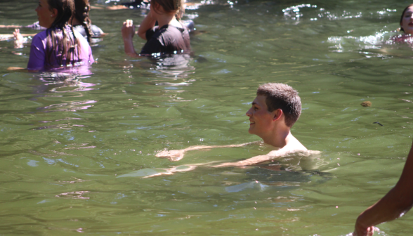 Student swims in the ponds