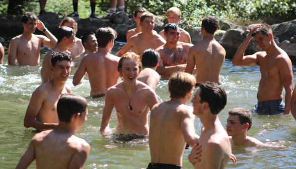 Men relax on one side of the pond