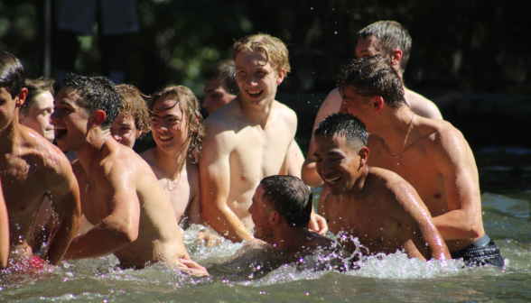 Students form a line in the pond