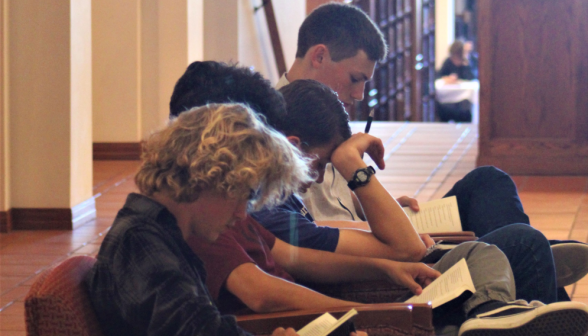 Students study in the library armchairs