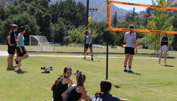 Outdoor volleyball: a student serves the ball