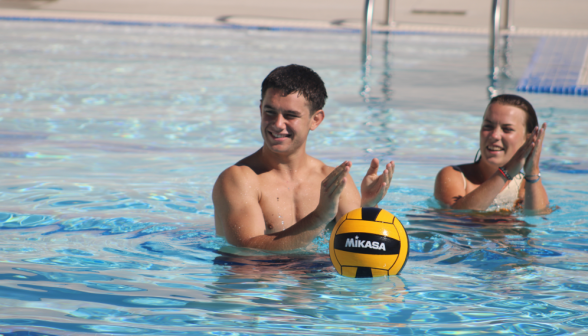 Two water poloists applaud an outstanding move