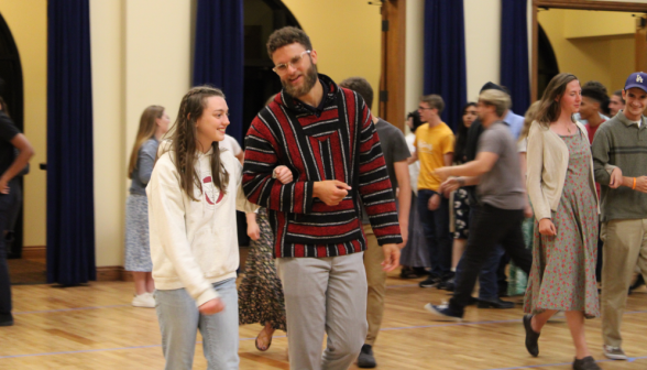 Arm in arm, a pair of students takes the floor for the practice