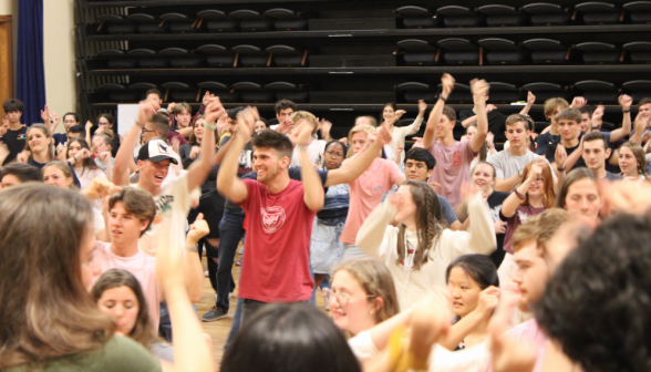 Students wave their hands in the air and snap their fingers