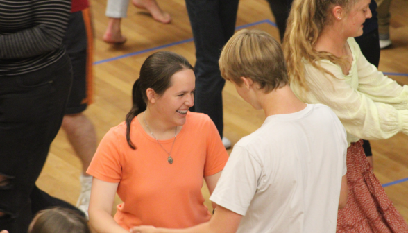 A student pair practices, with others all around