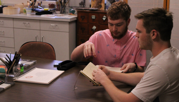 Two students sketch together