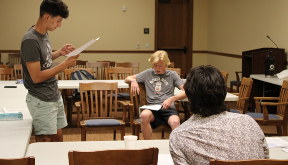 Three students read a document in the Dillon Seminar Room