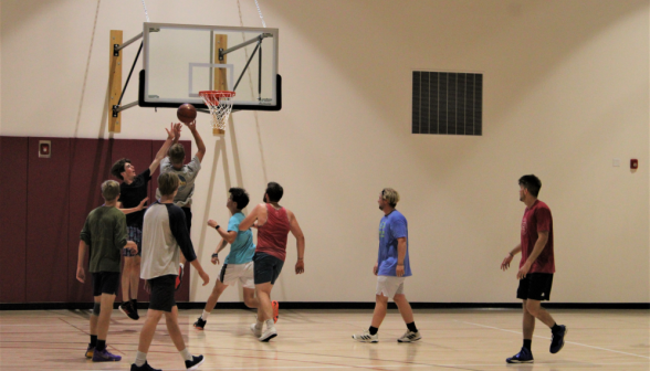 Basketball on the gym court: a student is about to shoot a hoop!