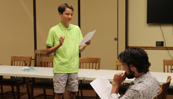 Two students practice their skit