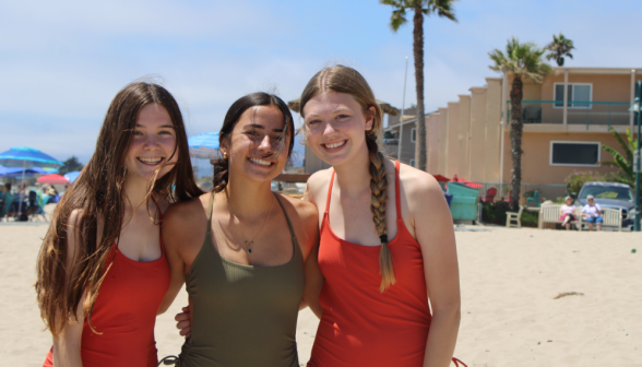 Three pose for a beach photo