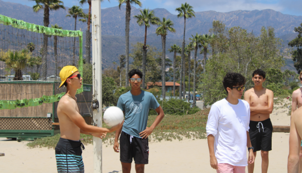 A game of beach volleyball develops