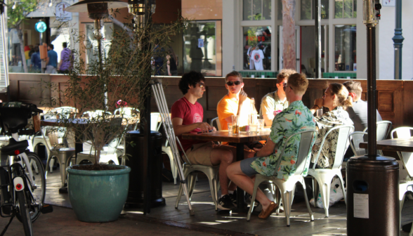 Six programmers at an outdoor table