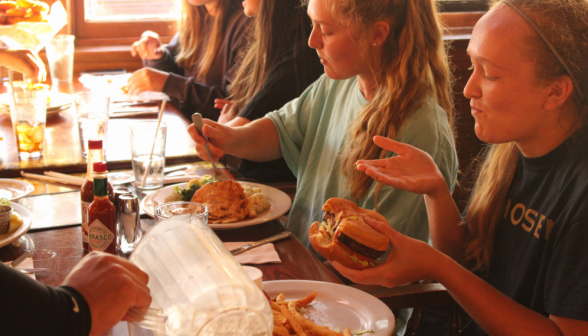 A student enjoys a burger