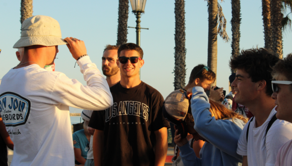 Students by a row of palm trees