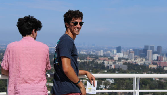 Two at the railing overlooking the city