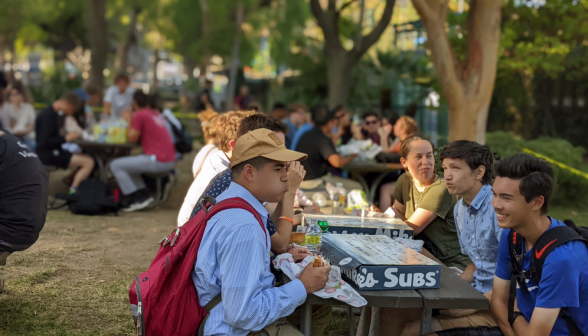 Students at picnic tables eat Jersey Mike's subs