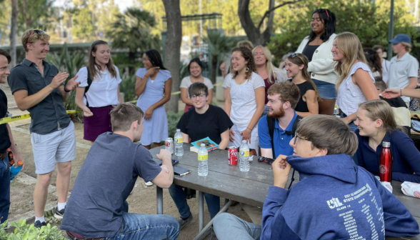 Laughter and applause around one of the tables