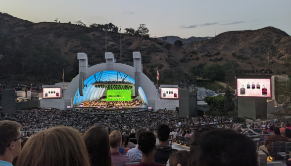Students watch the concert at the Hollywood Bowl while twilight fades from the L.A. hills in the background