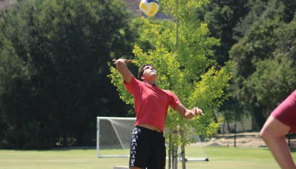 Volleyball: a student mid-serve