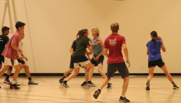 Mid-action: eight students in a game of basketball