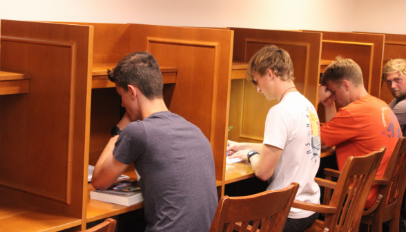 Four study at a row of desks