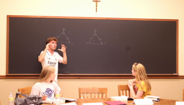A student gives a practice demonstration of Euclid I.4