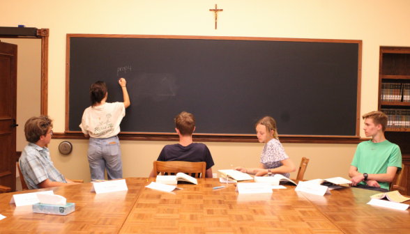 A student gives a practice demonstration of Euclid I.4