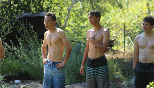 Three catch their breath, standing by the pond