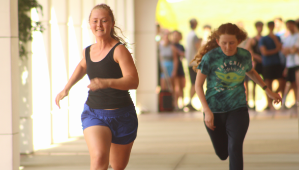 Two students sprinting before the onlookers