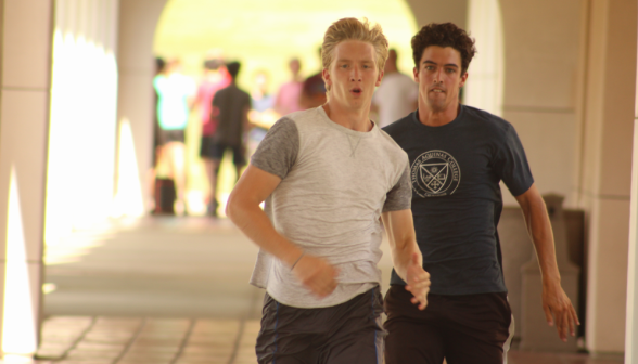 A student and a prefect barreling down the arcade