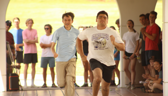 A student and a prefect running before onlookers