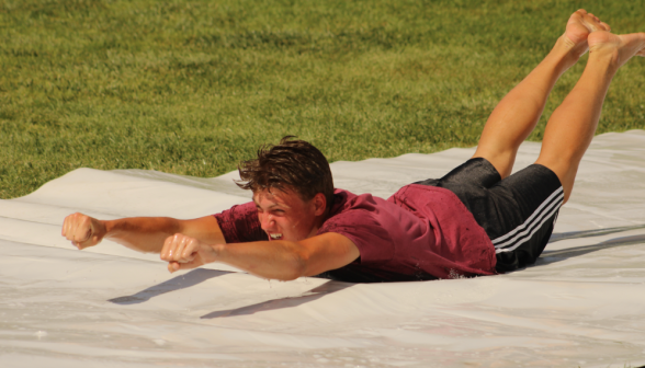 A student "Supermans" down the slide