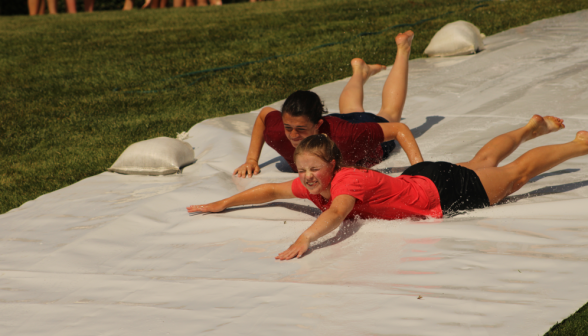 Two speeding down to the slide