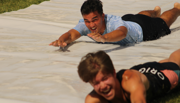 Two hurtle down the slide