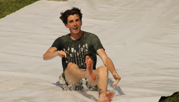 A student goes down the slide sitting