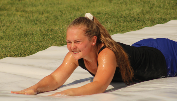 A student goes down the slide