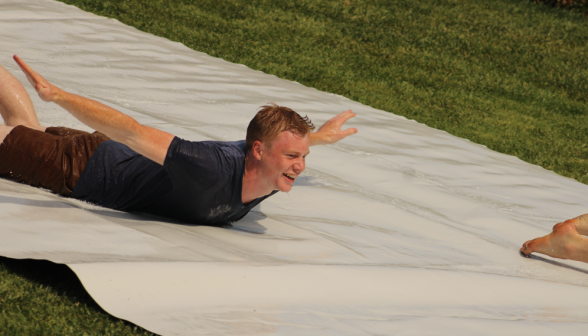 A student speeds down the slide