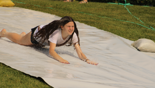 A student goes down the slide