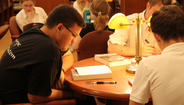 Three focused, studying at their table