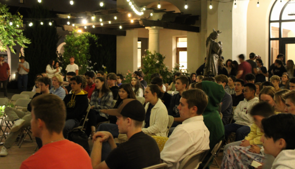 Students listen, seated in their chairs