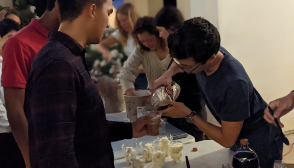 Students get ice cream floats at the refreshments table in the back