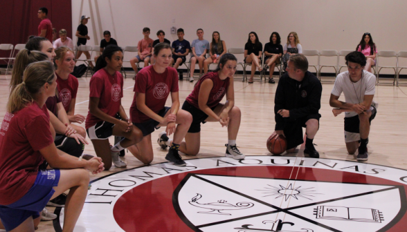 The women's teams pray pre-game