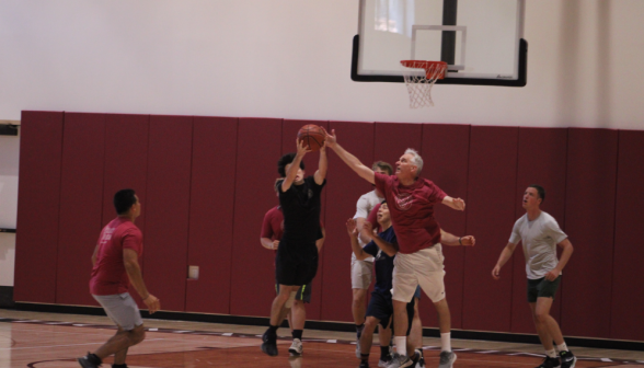 A student takes a shot, while Fr. Walshe attempts to block