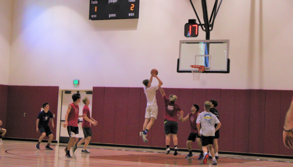 A student leaps into the air to take a shot