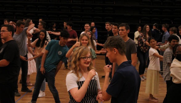 Two students chatting and dancing