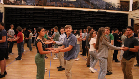 The students, paired up, in rows across the dancefloor