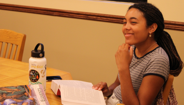 A student studying smiles for the camera