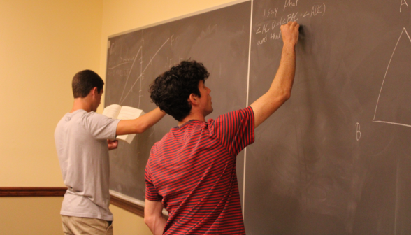 Two students practice at the board