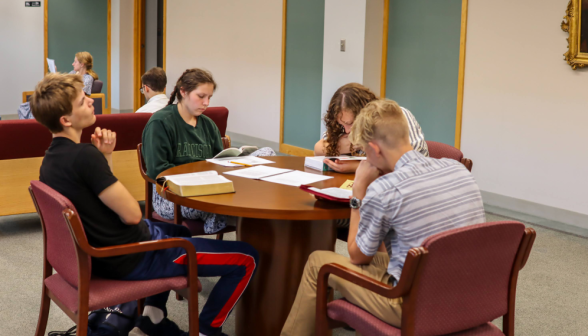 Four studying at a circular table